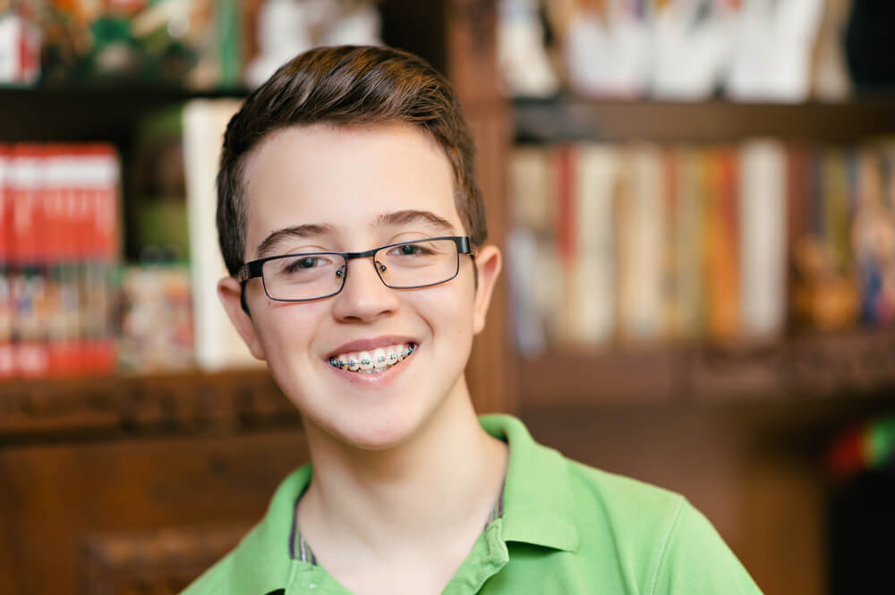 Happy boy with braces and glasses. smiling